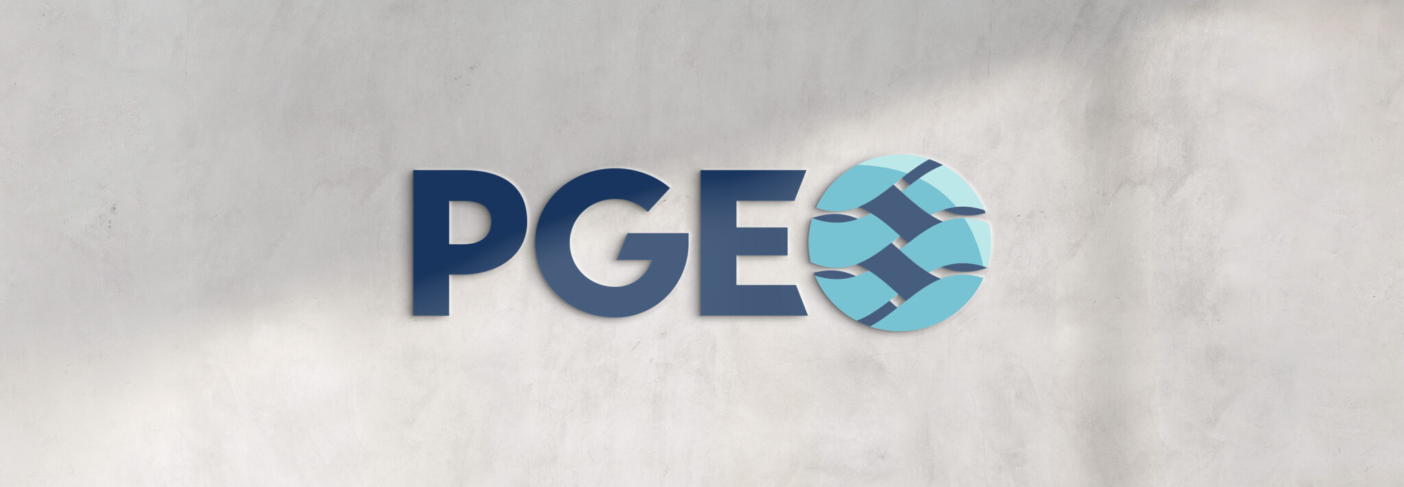 The PGE logo on a concrete wall.