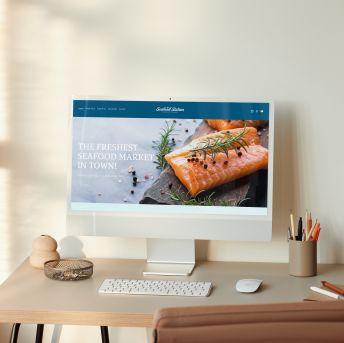 A mockup showing the seafood station website homepage on a computer screen.