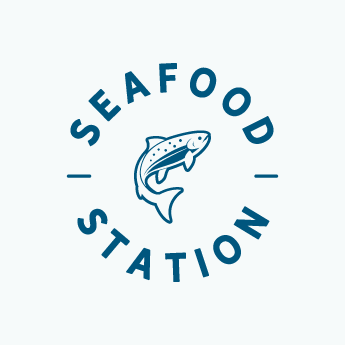 An alternate Seafood Station logo, in a circular "badge" format with navy blue sans serif font on white background, with a leaping salmon in the center of the logo.